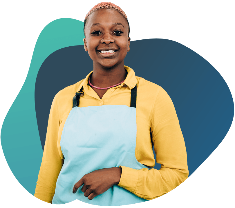 Woman smiling in apron representing business financing solutions.