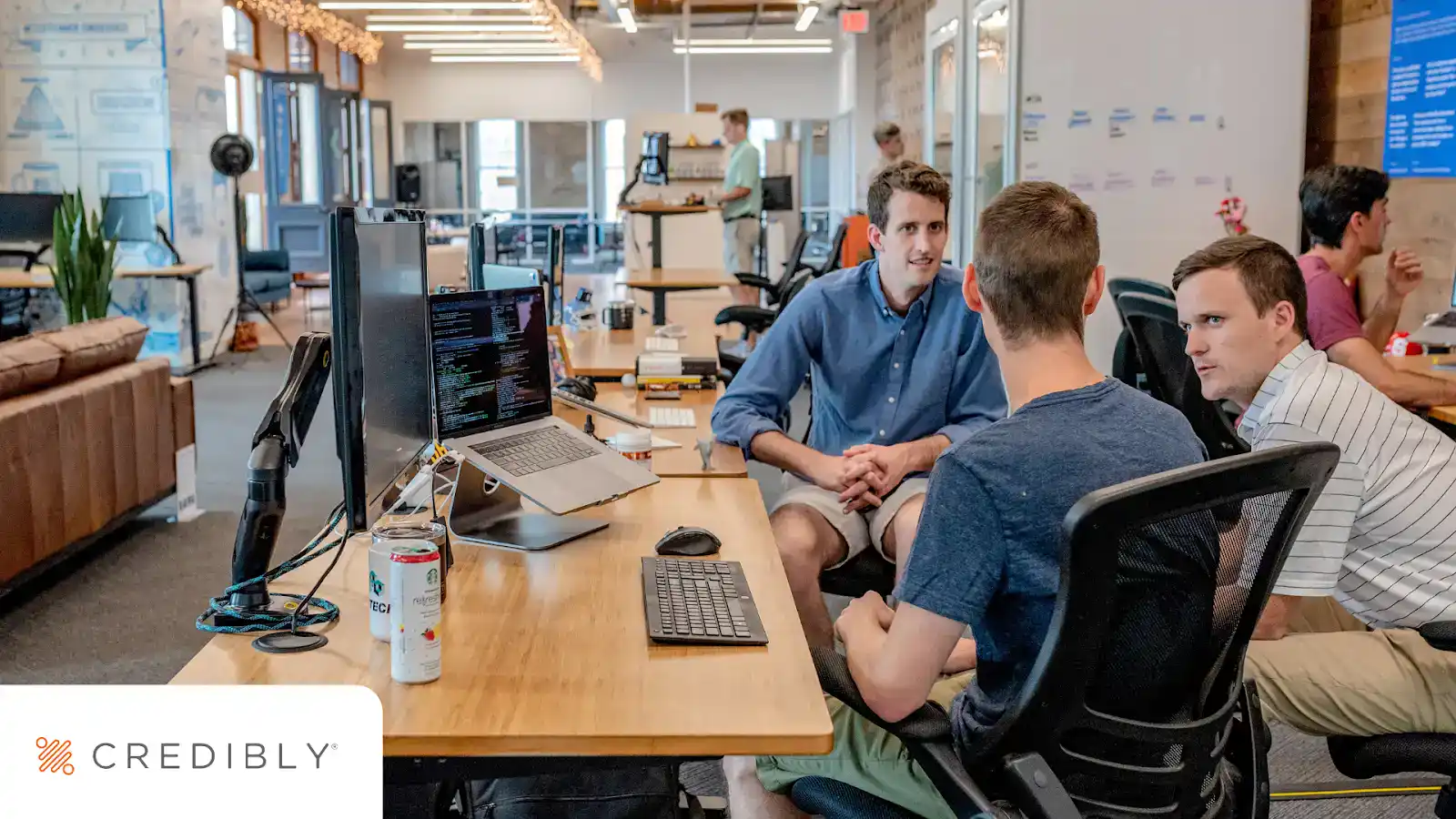 Business team discussing revenue-based financing options in a modern office.