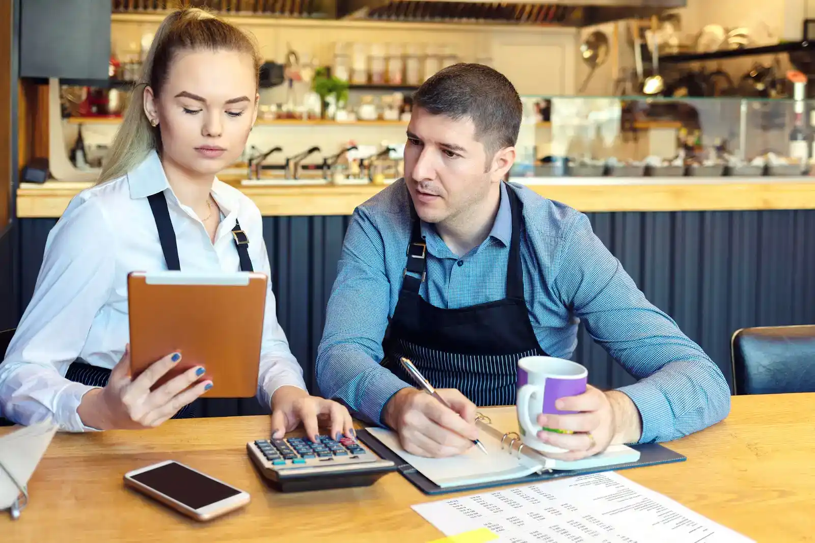 Business owners reviewing loan options for small business growth.