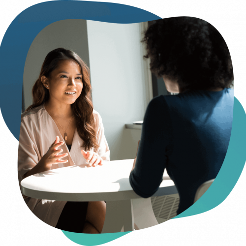 Businesswoman discussing revenue-based small business loan options with advisor.