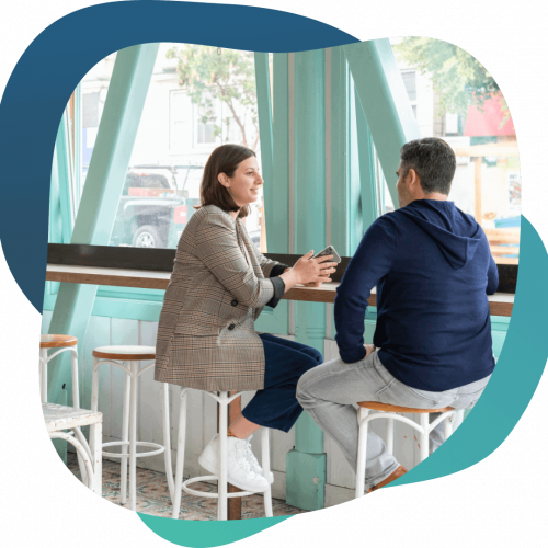 Business owners discussing financing options at a cafe.