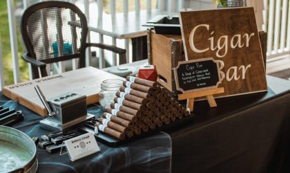 Cigar bar display with cigars and accessories at an outdoor event.