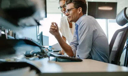 Business team discussing financial data at office desk.