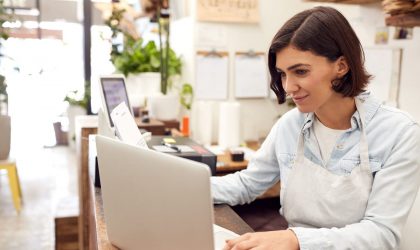 Small business owner doing paperwork to determine the best financing option for him by taking right-sized capital with the best factor rate