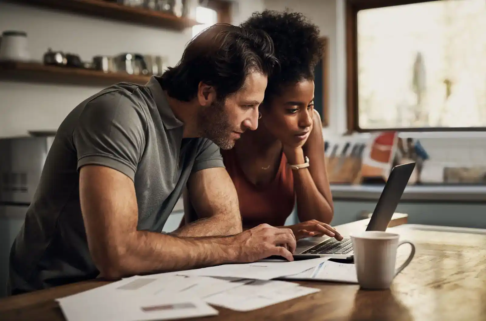 Two professionals reviewing business credit scores on a laptop in a modern office.