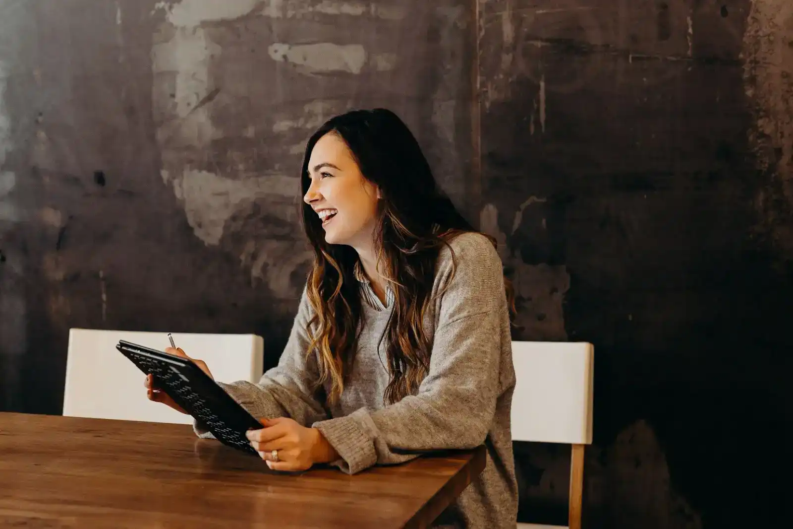 Woman enjoying her meal with a menu, representing restaurant working capital solutions.